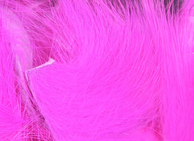 Hareline Magnum rabbit fur strips in vibrant hot pink, soft long hairs for fly tying, close-up texture and fine fibers