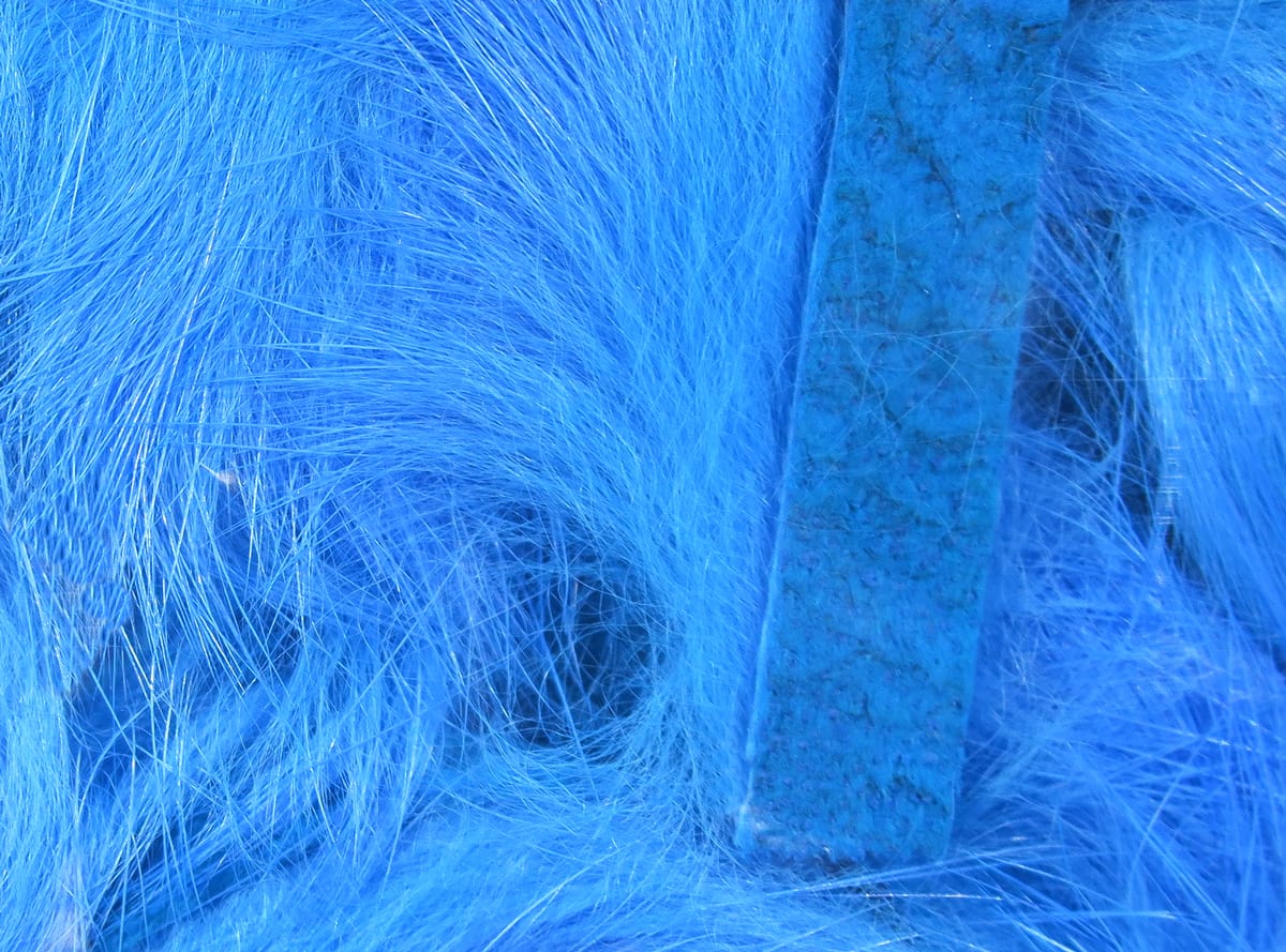 Bright blue Hareline Magnum rabbit fur strips with silky long guard hairs and leather backing for fly tying