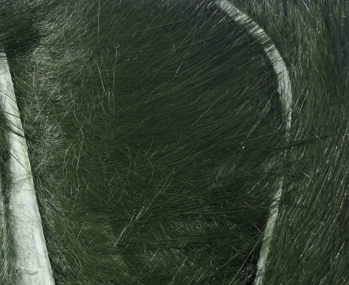 Dark olive-green rabbit fur strips with long glossy guard hairs and soft underfur on white backing, ideal for fly tying