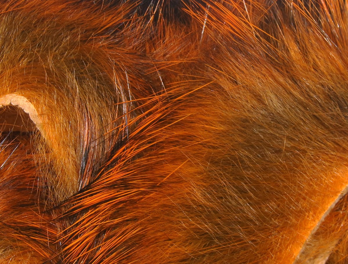 Hareline Magnum rabbit fur strips in rich burnt orange and brown with long glossy guard hairs for fly tying