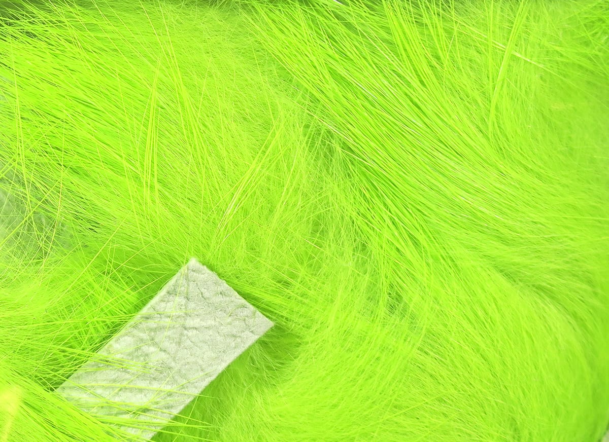 Neon chartreuse Hareline Magnum rabbit fur strip with long soft hairs and white leather backing for fly tying
