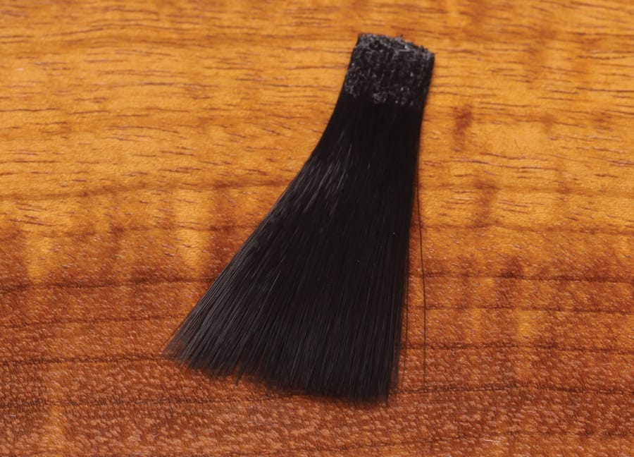 Black synthetic mayfly tails bundle with adhesive band and tapered hair fibers for fly tying