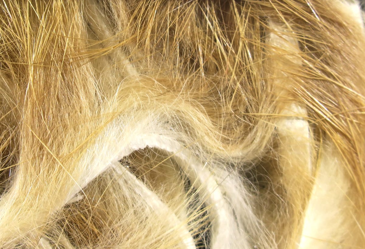 Golden tan micro rabbit fur strips with fine soft underfur and long guard hairs on white backing for fly tying