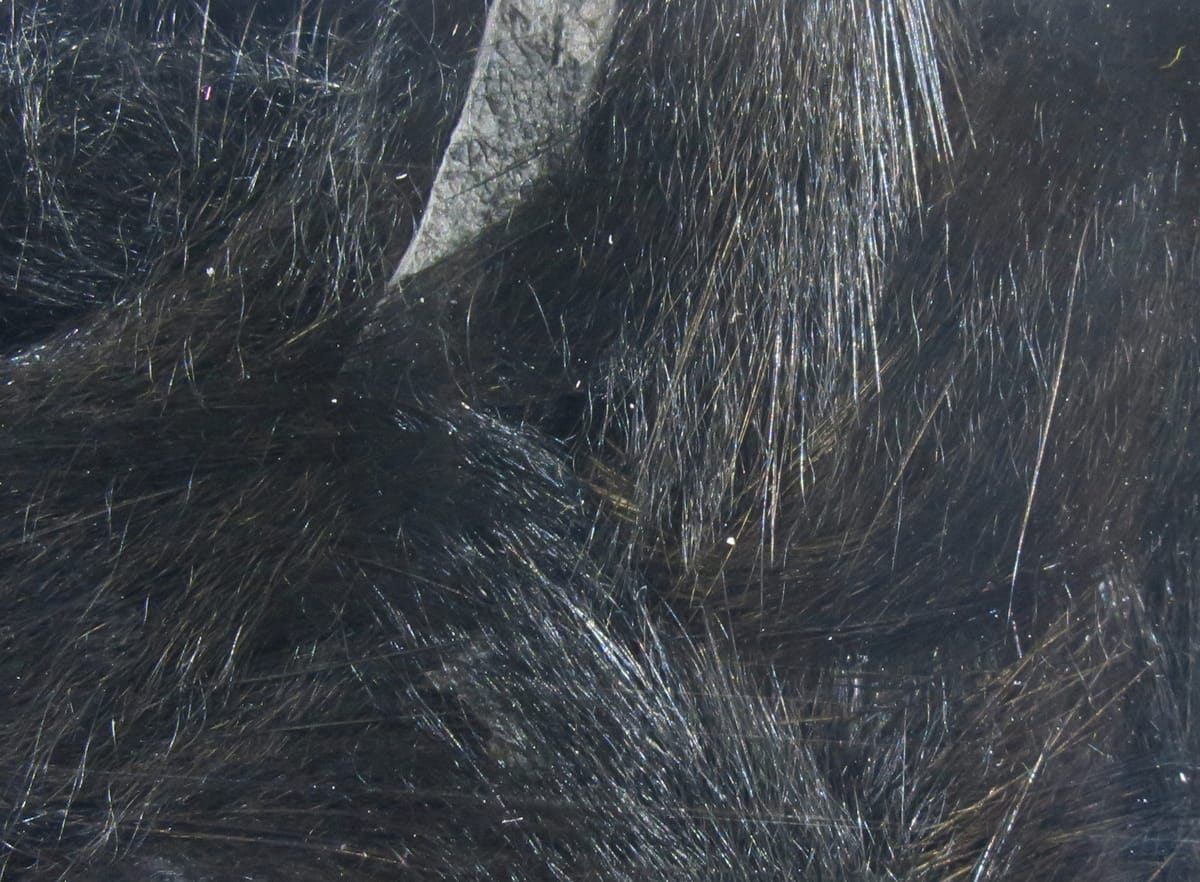 Hareline micro rabbit fur strips glossy black-brown with fine, soft hairs and natural texture for fly tying