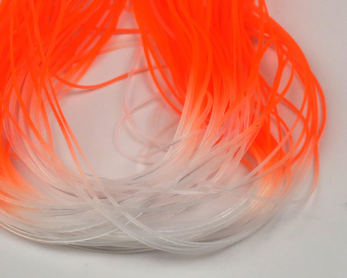 Bright fluorescent orange-to-white micro silicone legs for fly tying, thin flexible strands coiled in a loop