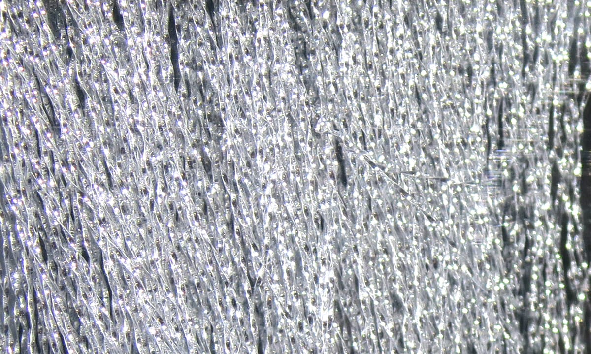 Silver Hareline Midge Flash synthetic strands with fine metallic sparkle for fly tying