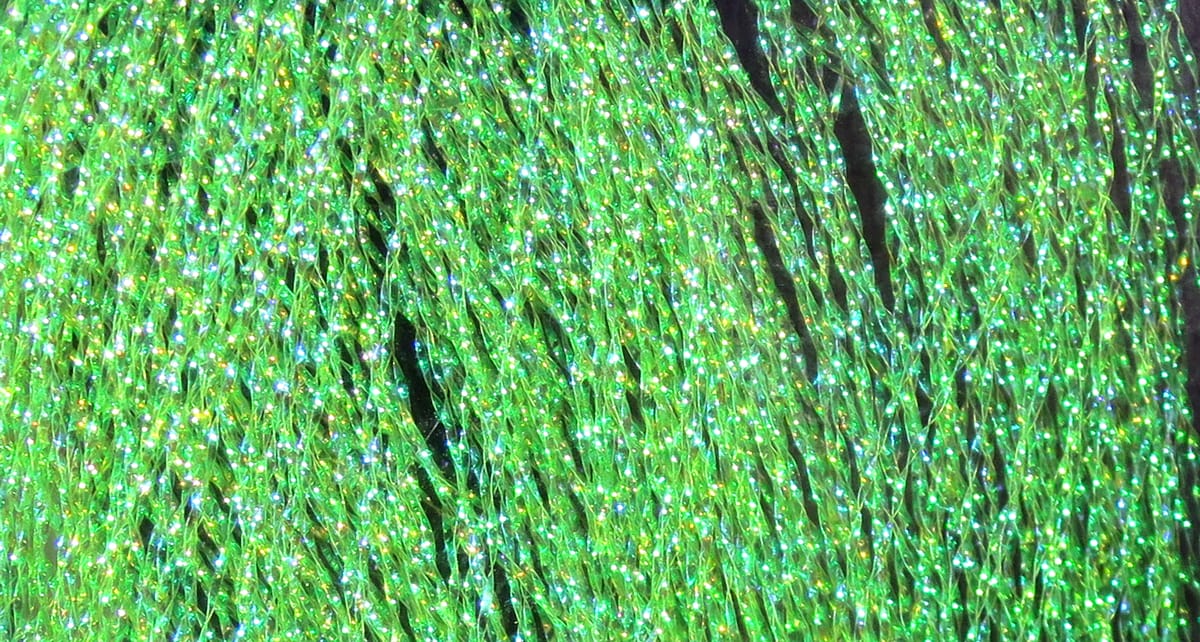Iridescent chartreuse synthetic strands of Hareline Midge Flash, braided glittery flash material for fly tying