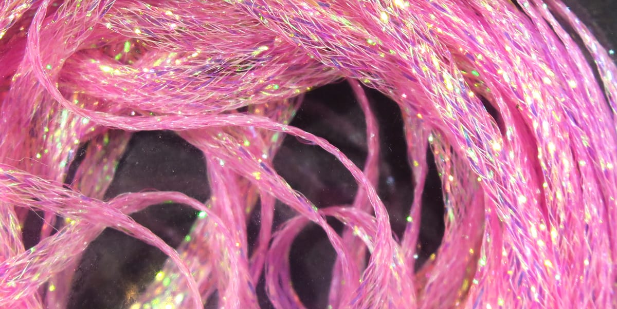 Pink iridescent mini flat fly braid strands, shiny synthetic fibers twisted into thin flat braid for fly tying