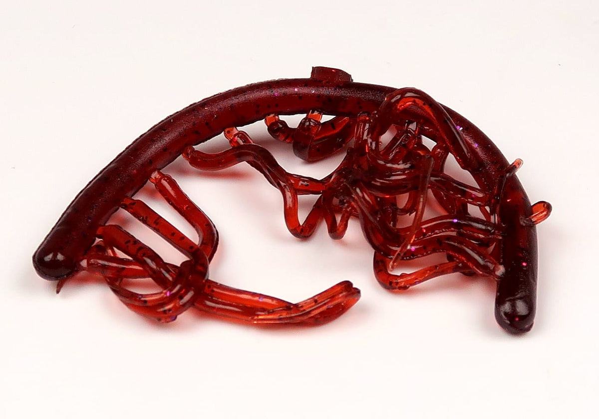 Red translucent soft-plastic mini squiggle worms with glitter flecks and curly tentacles for fly tying