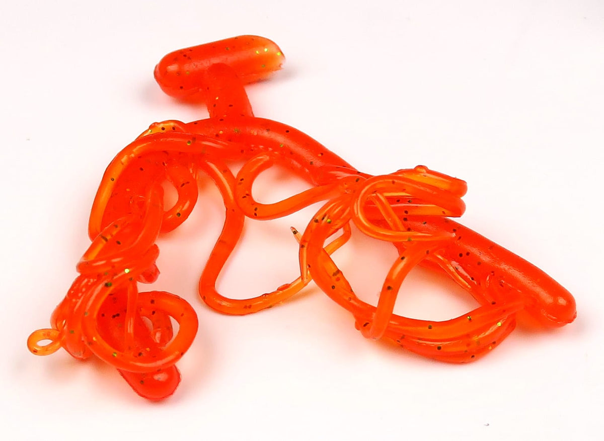 Hareline Mini Squiggle Worms bright translucent orange soft-plastic curly worm strands with green glitter for fly tying