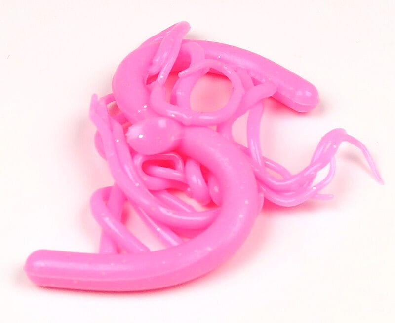 Bright pink Hareline Mini Squiggle Worms soft plastic fly tying worms with glossy, curly tentacles