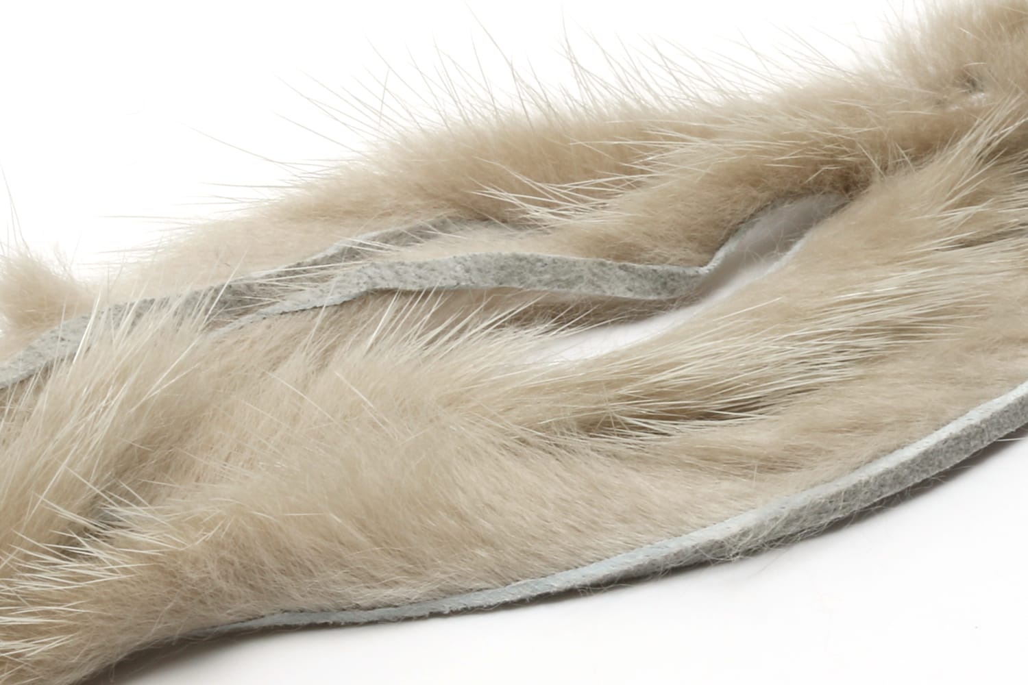 Light tan Hareline mink strips with soft long fur and gray suede backing, ideal for fly tying