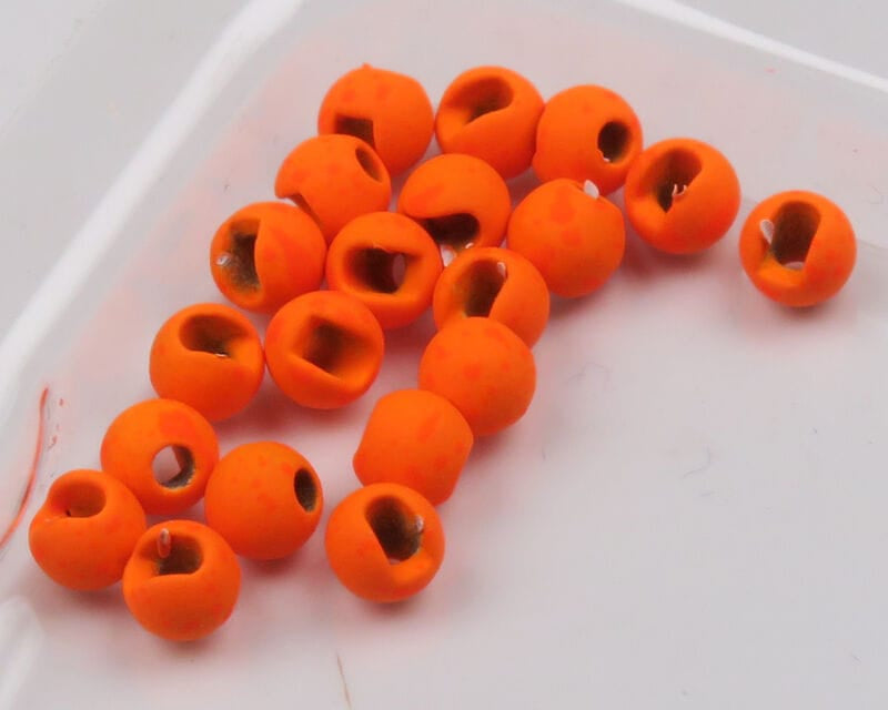 Mottled bright orange slotted tungsten beads for fly tying, round matte finish with visible inner slots and holes
