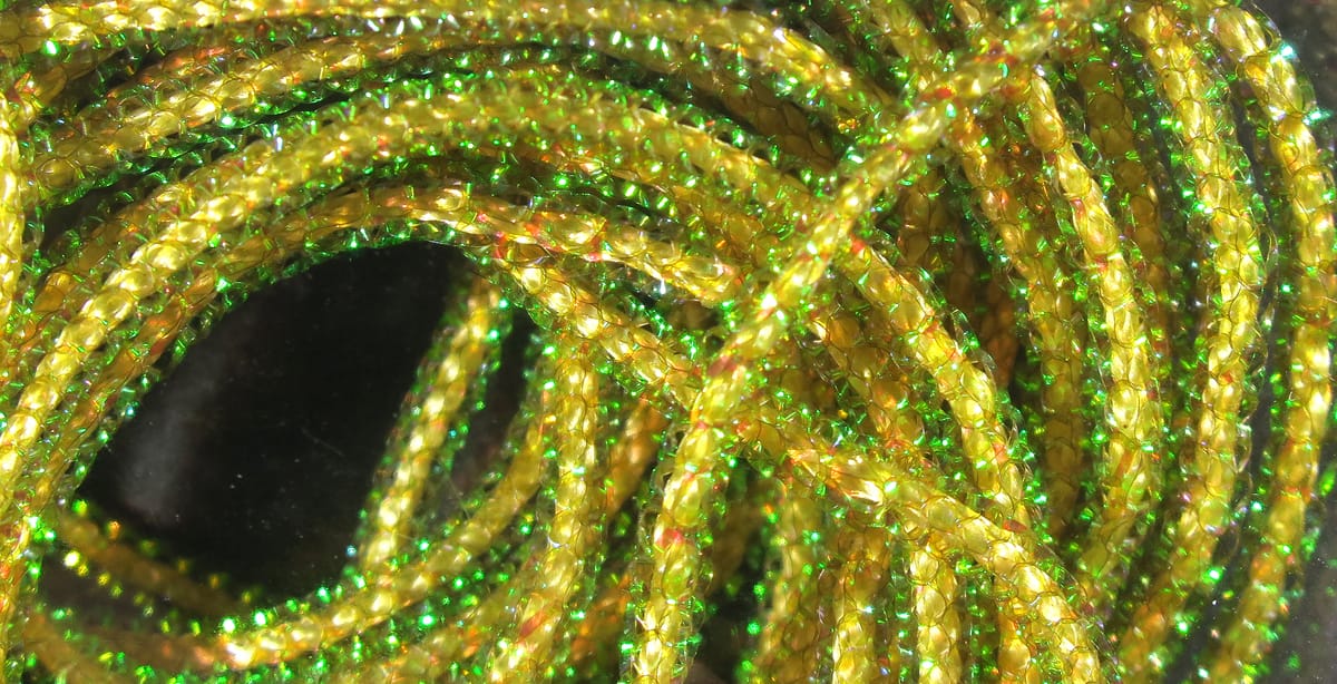 Hareline Pearl Core Braid gold-yellow braided synthetic with green iridescent flash for fly tying.