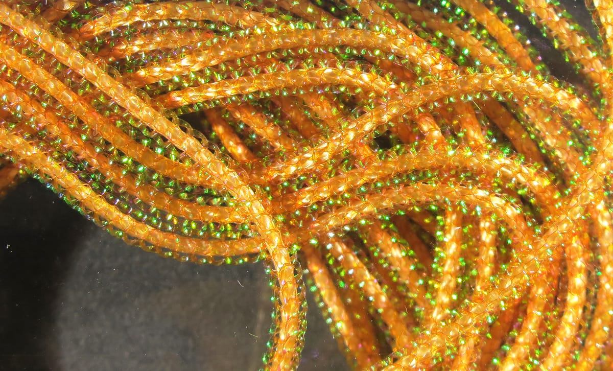 Hareline Pearl Core Braid braided translucent orange-gold tinsel with green iridescent core for fly tying