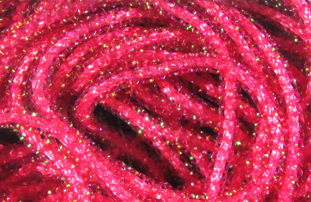 Hareline Pearl Core Braid bright hot pink braided synthetic with green iridescent flashes for fly tying