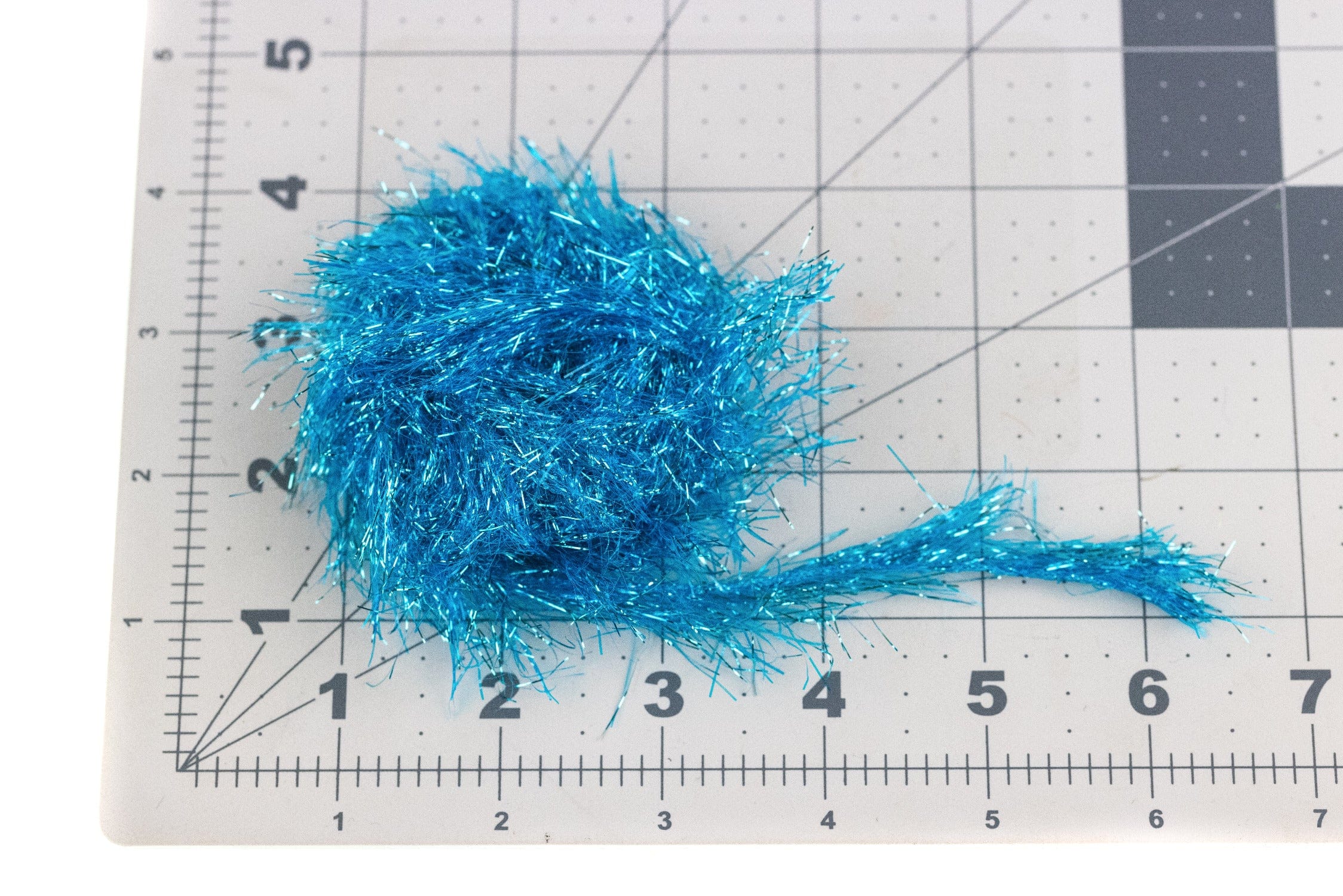 Bright turquoise metallic flash chenille bundle with sparkling reflective tinsel strands for fly tying