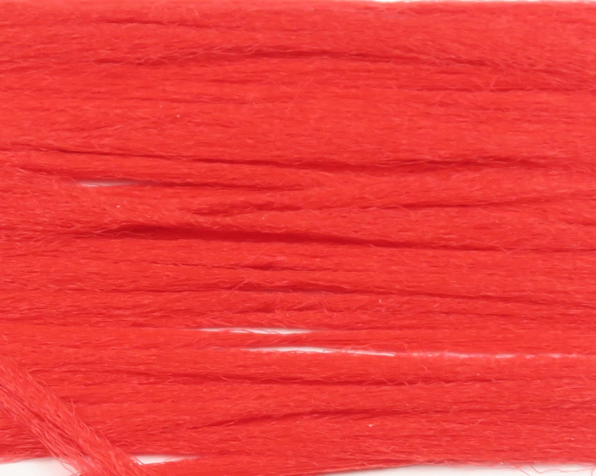 Bright red Hareline polypropylene floating yarn strands with slightly fuzzy texture for fly tying
