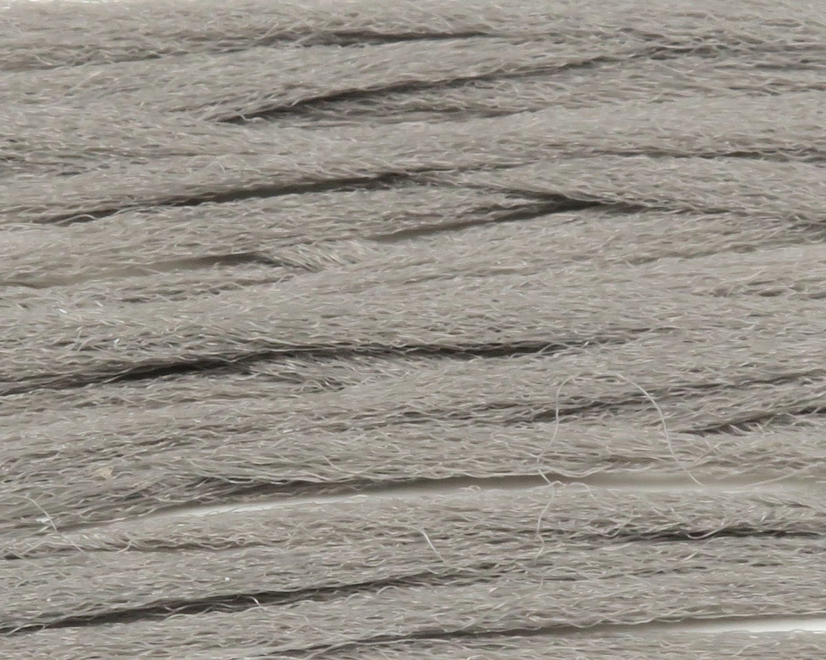 Pale gray Hareline polypropylene floating yarn, layered fibrous synthetic strands with fuzzy texture for fly tying