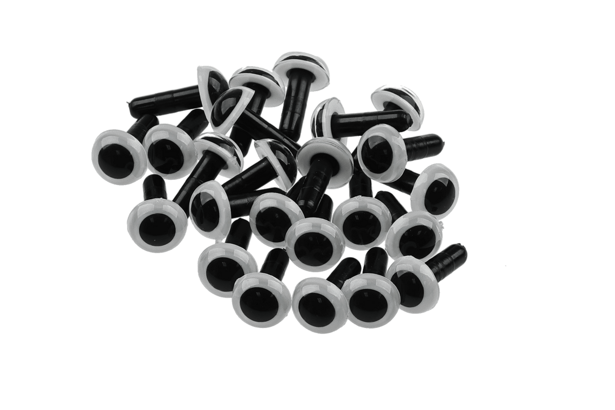 Pile of black plastic posted dome eyes with white rims for fly tying lures