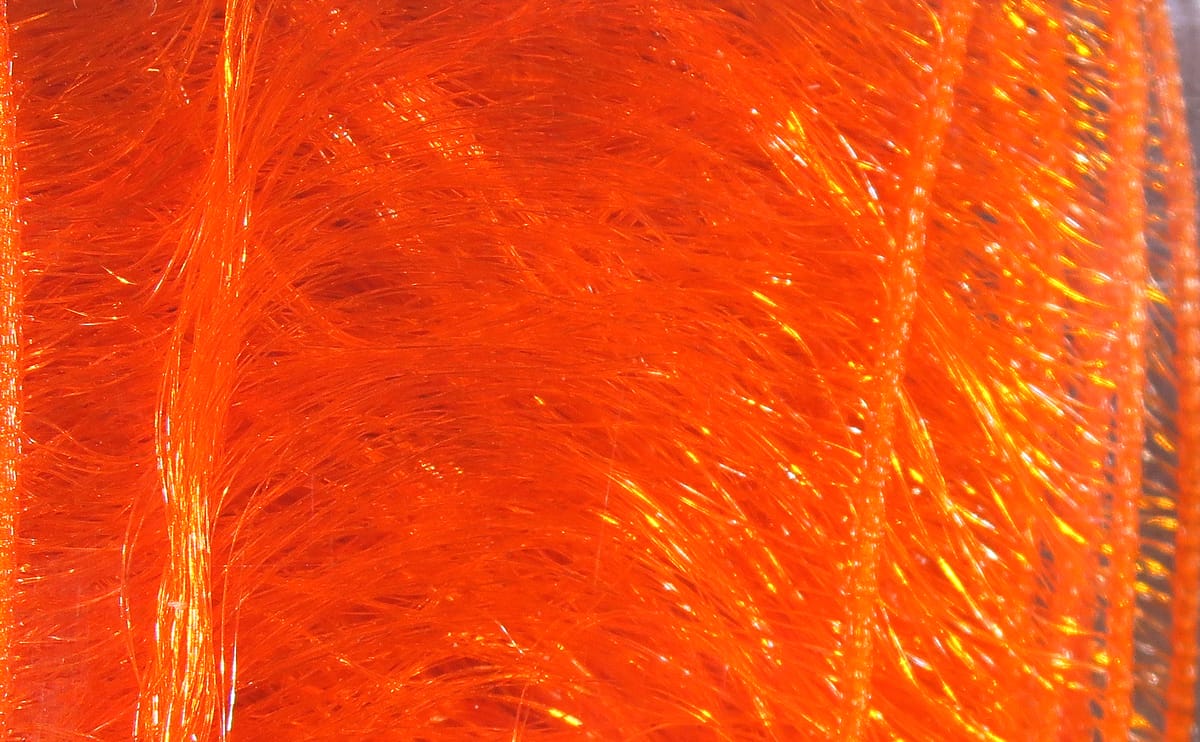 Hareline pseudo hackle bright orange synthetic fibers with iridescent flash, dense feather-like strands for fly tying