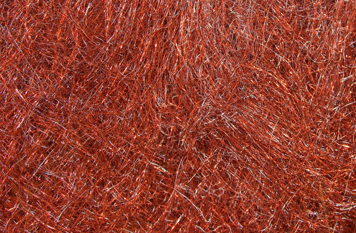 Copper-red synthetic dubbing fibers with metallic flash, fine wispy texture for fly tying