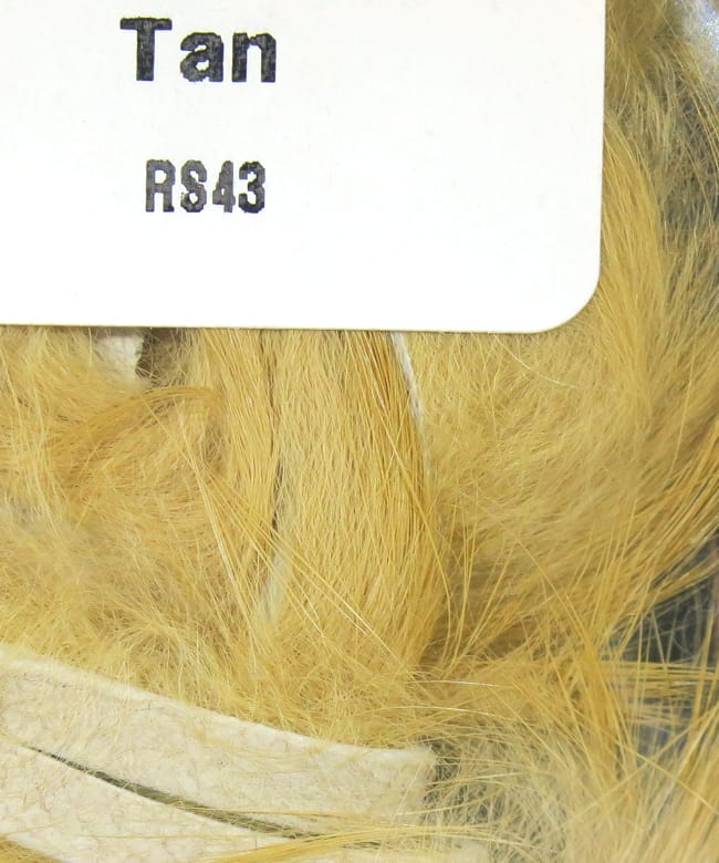 Tan Hareline rabbit fur strips for fly tying — soft fine fur attached to leather strip, natural golden-tan color
