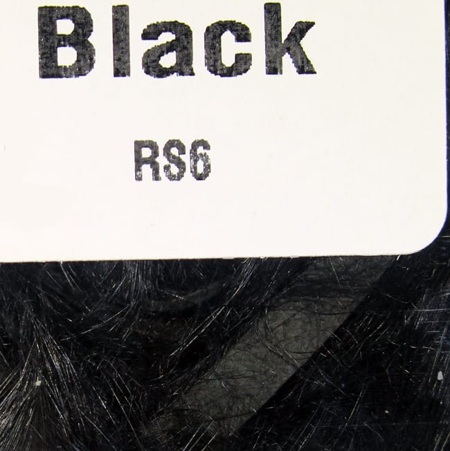 Hareline black rabbit fur strips for fly tying, glossy long black fibers visible beneath white product label marked Black
