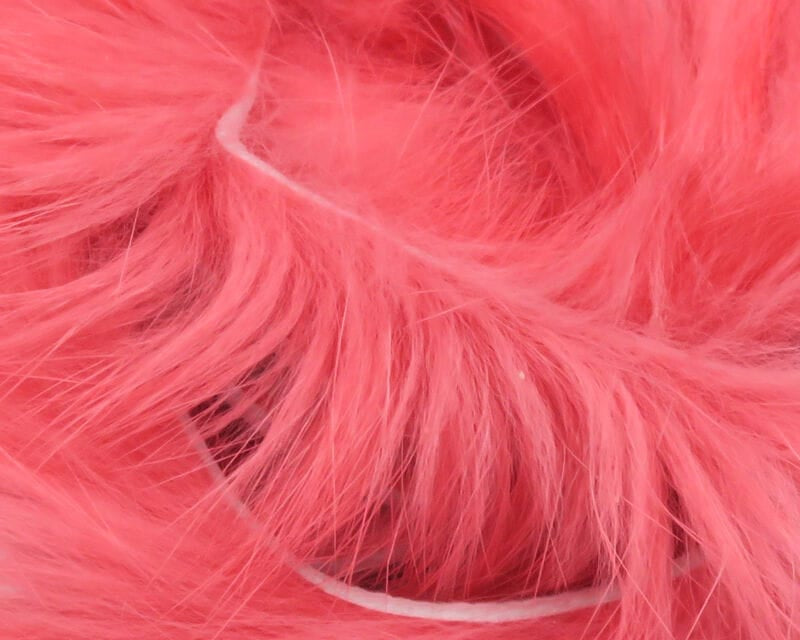 Bright pink Hareline rabbit fur strips with long soft fluffy fibers on white strip backing