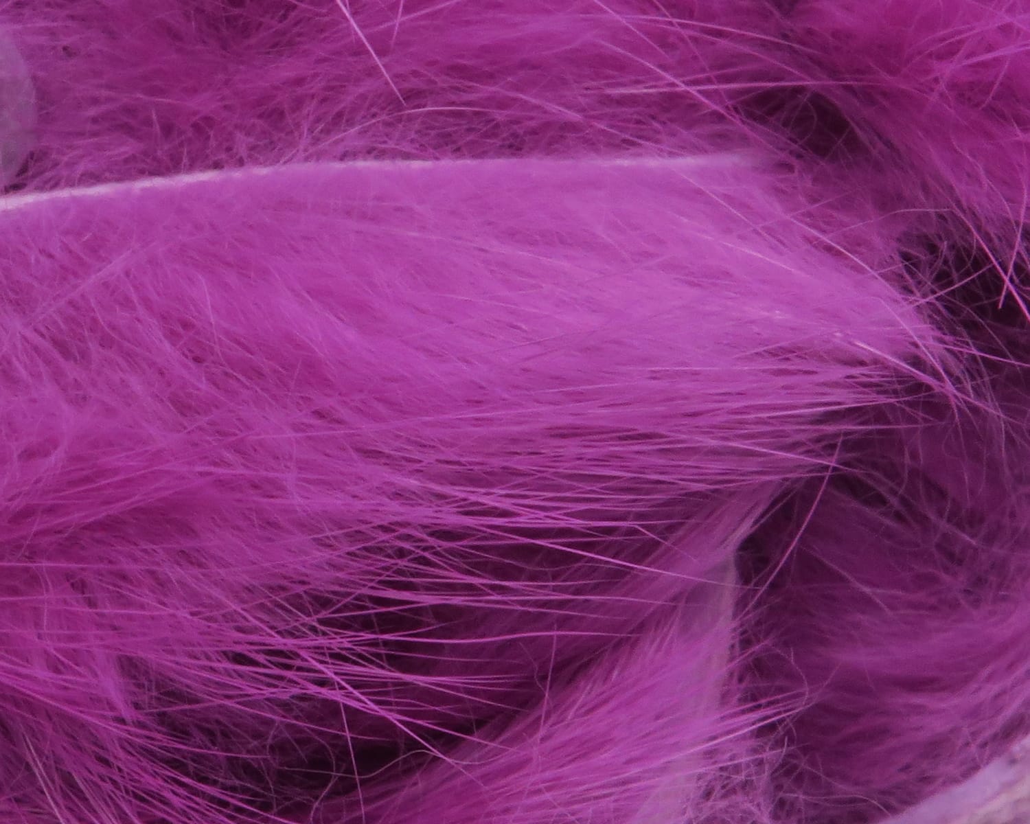 Bright magenta Hareline rabbit fur strips for fly tying, soft long guard hairs and fluffy dense underfur