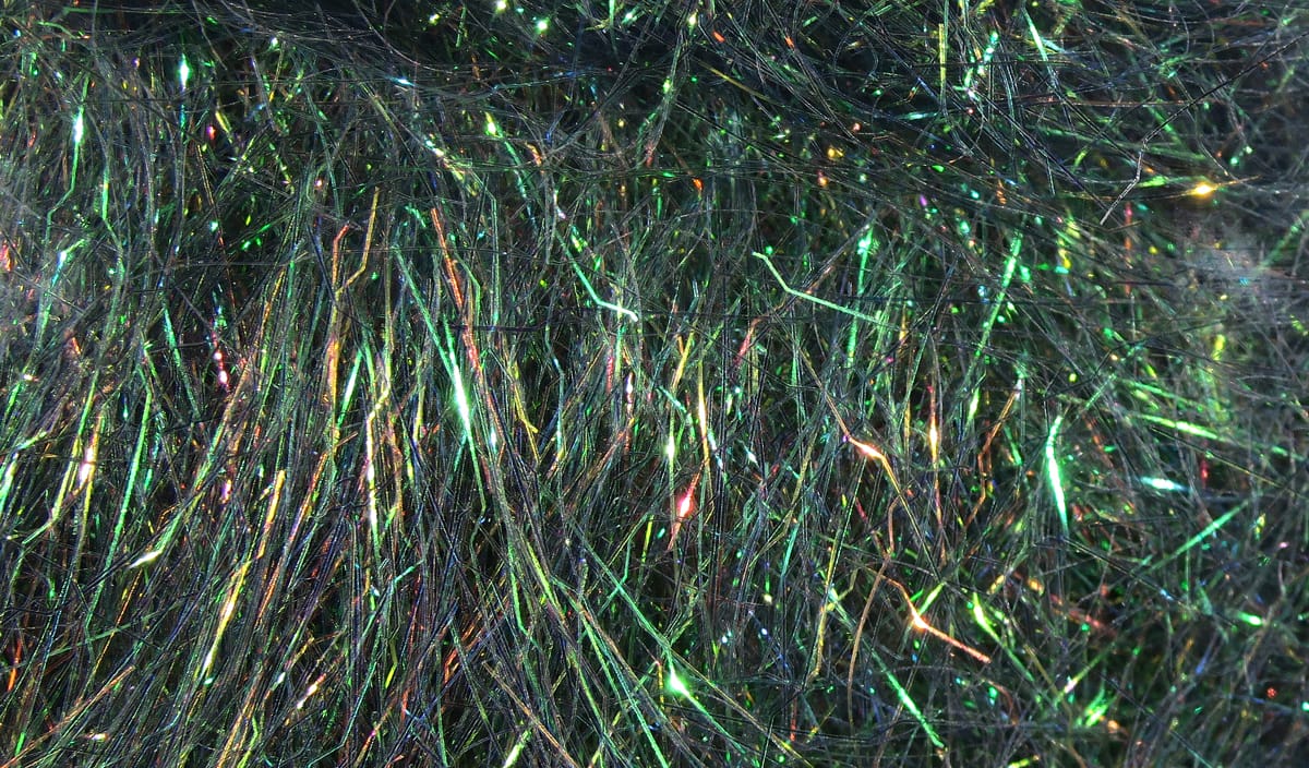 Iridescent black-green Ripple Ice dubbing with long shimmering synthetic fibers and tinsel-like flash for fly tying