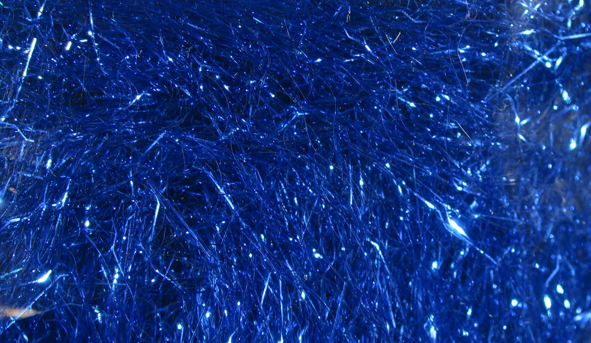 Deep metallic blue Hareline Ripple Ice Dub with fine iridescent synthetic fibers and sparkly rippled strands for fly tying