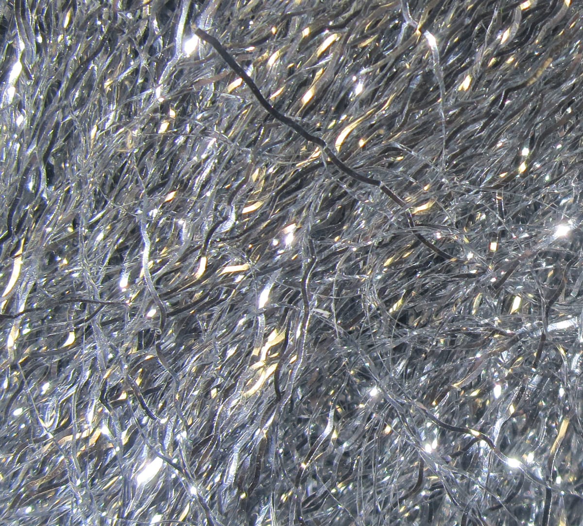 Hareline Ripple Ice Fiber silver iridescent crinkled synthetic strands with sparkle, rippled textured fly tying material