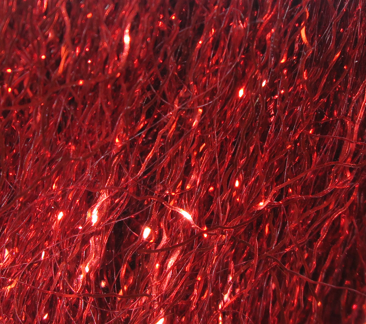 Shimmering red Hareline Ripple Ice synthetic fiber with rippled, glittering strands for fly tying