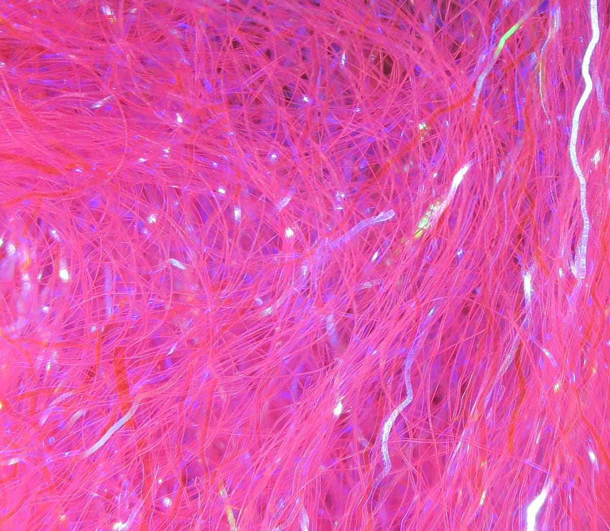 Hot pink Hareline Ripple Ice fiber, fine synthetic strands with iridescent wavy tinsel for fly tying