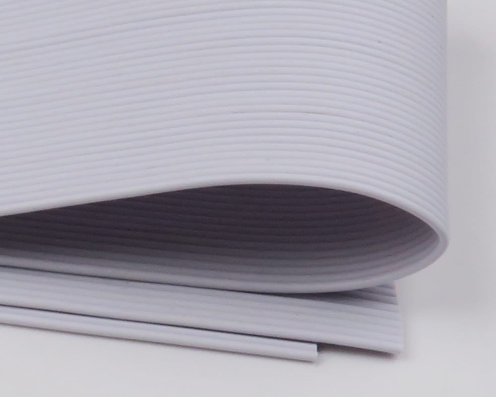 Rolled white round ribbed rubber legs, flexible synthetic tubing for fly tying, Hareline brand
