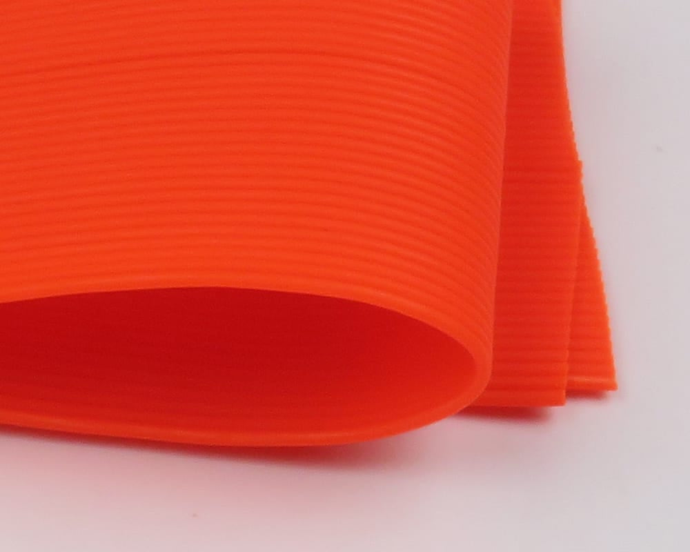 Hareline round rubber legs fluorescent orange ribbed rubber tubing, rolled flat for fly tying