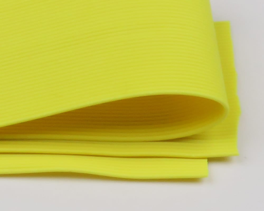 Chartreuse round rubber legs for fly tying, ribbed flexible rubber strips rolled and stacked
