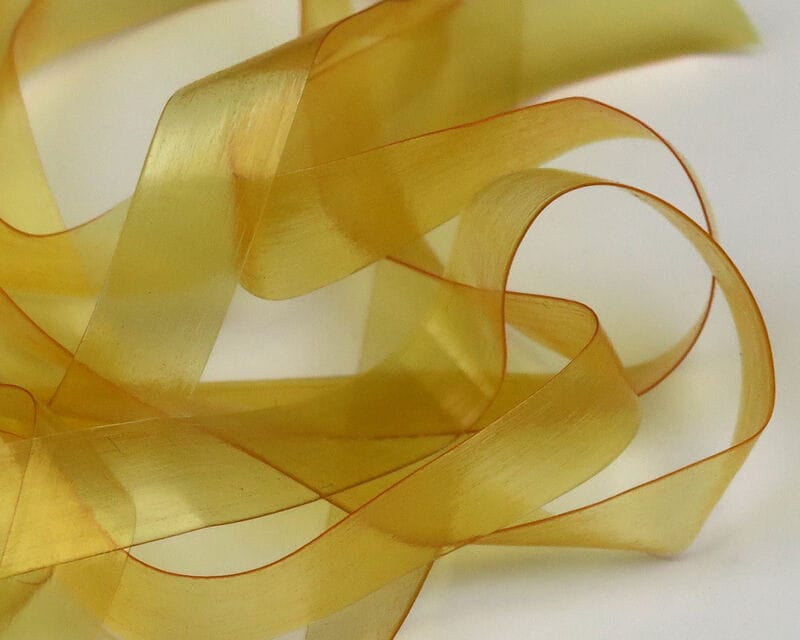 Translucent golden Scud Back synthetic ribbon with thin orange border for fly tying nymphs