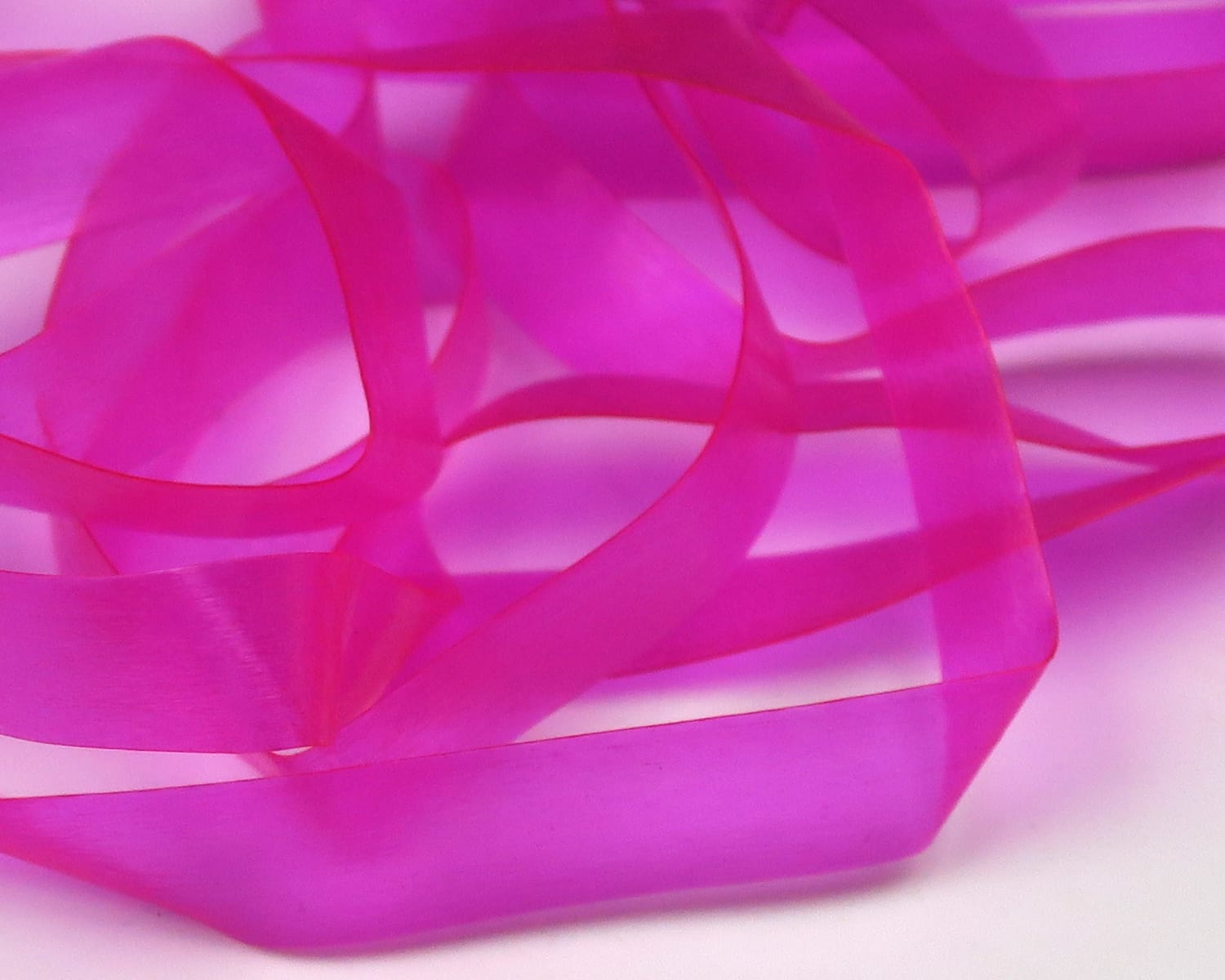 Hareline Scud Back hot pink translucent plastic ribbon, smooth sheer scud material for fly tying