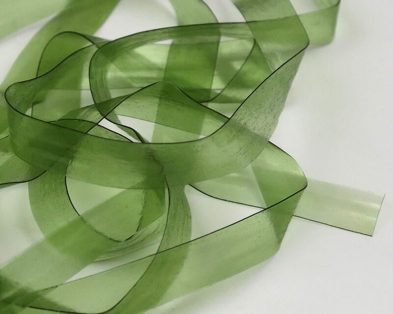 Olive green translucent Hareline Scud Back strips for fly tying, smooth flexible plastic ribbon with dark edge