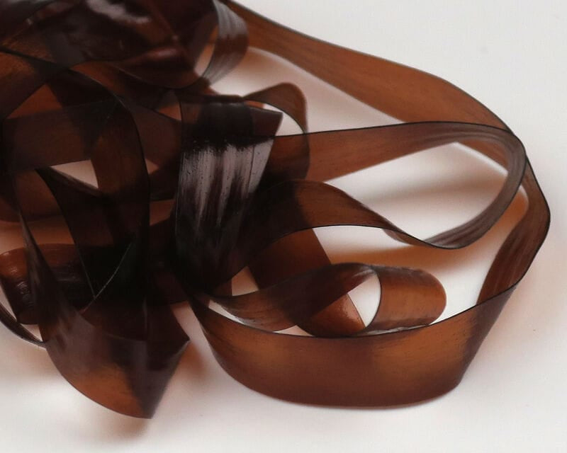Dark amber translucent Scud Back ribbon strips, glossy synthetic material for fly tying nymph bodies