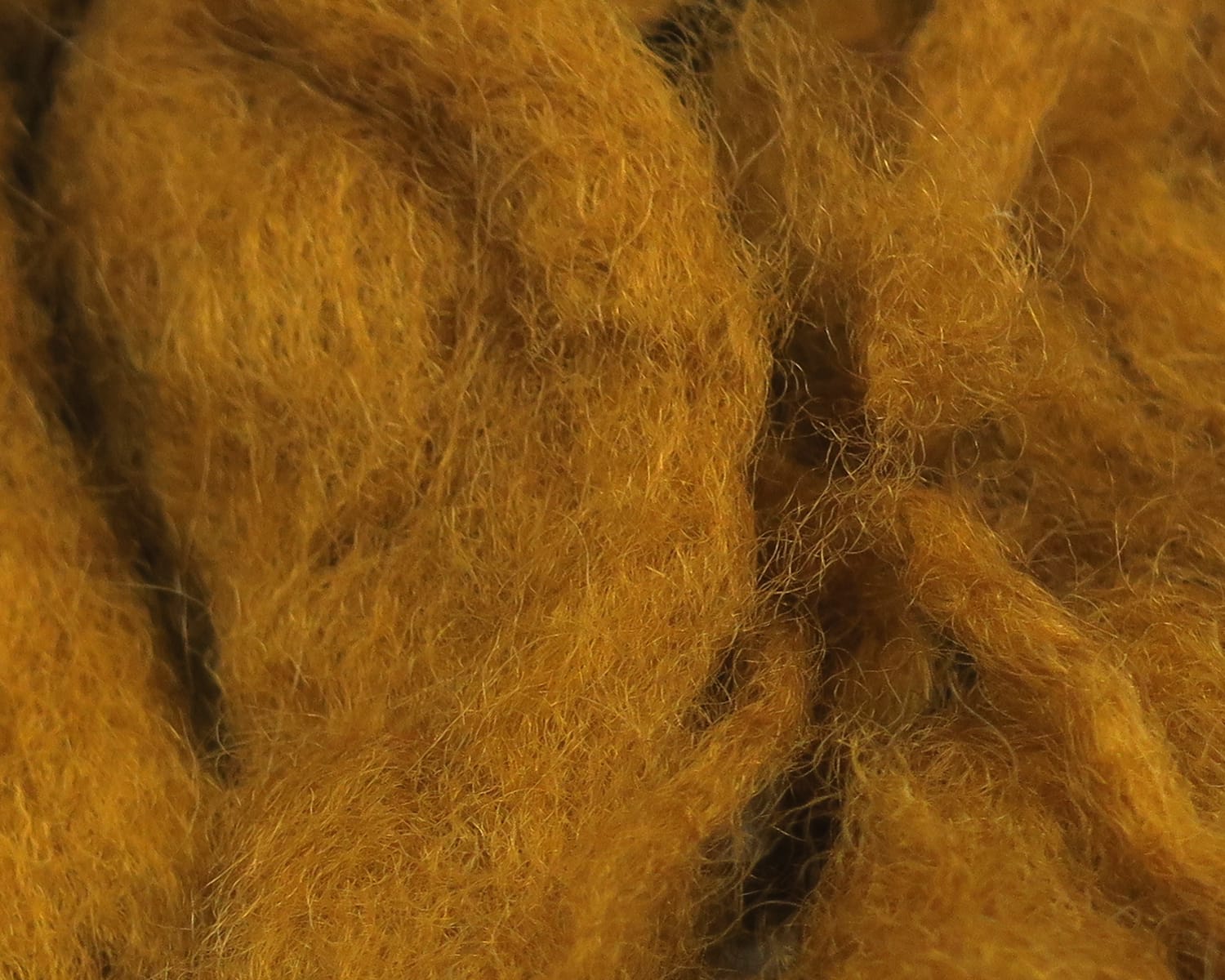 Hareline Sculpin wool in golden-brown fuzzy loose fiber bundles for fly tying