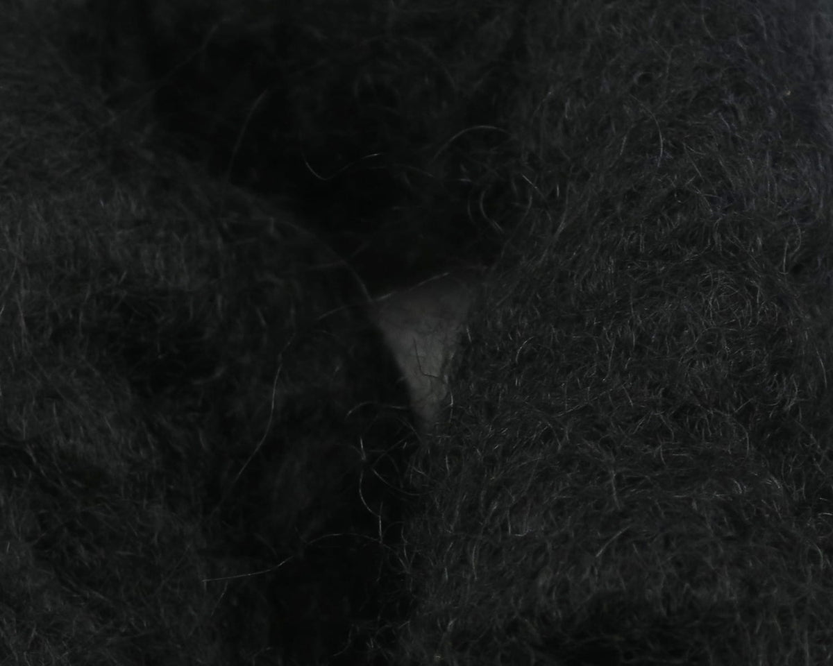 Black sculpin wool, dense fuzzy fibers with wispy guard hairs, ideal for fly tying sculpin patterns