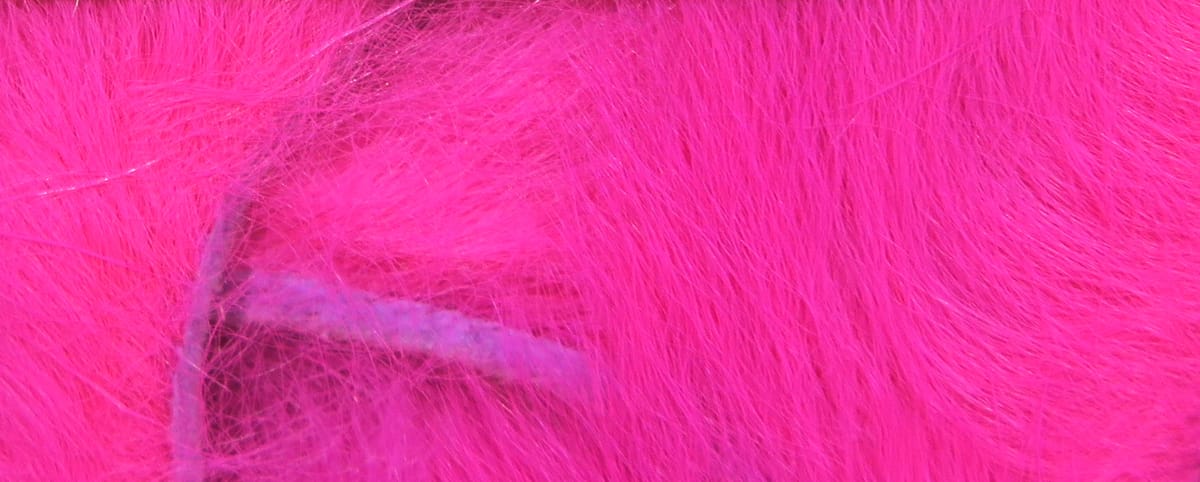 Bright hot-pink silky bunny fur strips with dense soft fibers and subtle iridescent fibers for fly tying