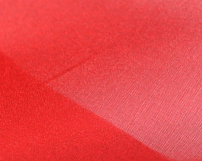 Red sparkle organza fabric with sheer fine weave and glittery shimmer, ideal for fly tying materials