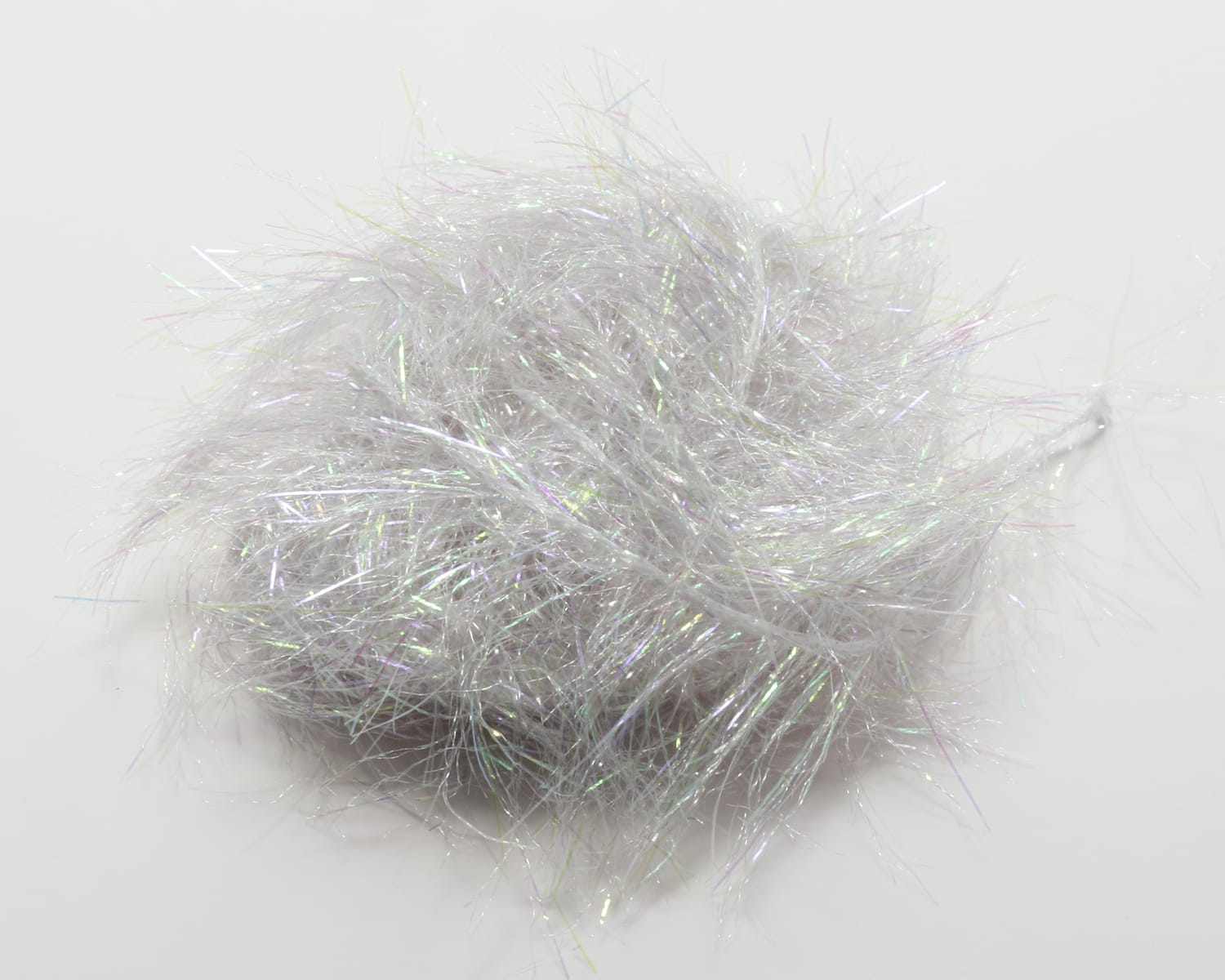 Ball of silvery white iridescent glimmer chenille with fine tinsel-like fibers, fluffy texture for fly tying