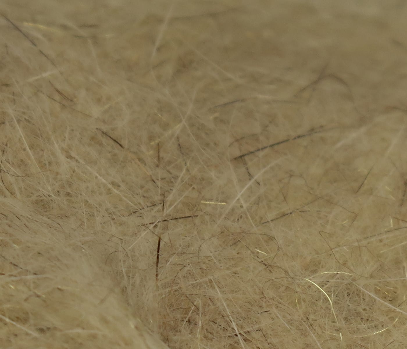 Hareline squirrel hair dubbing close-up, tan fluffy underfur with darker guard hairs and subtle gold flash for fly tying