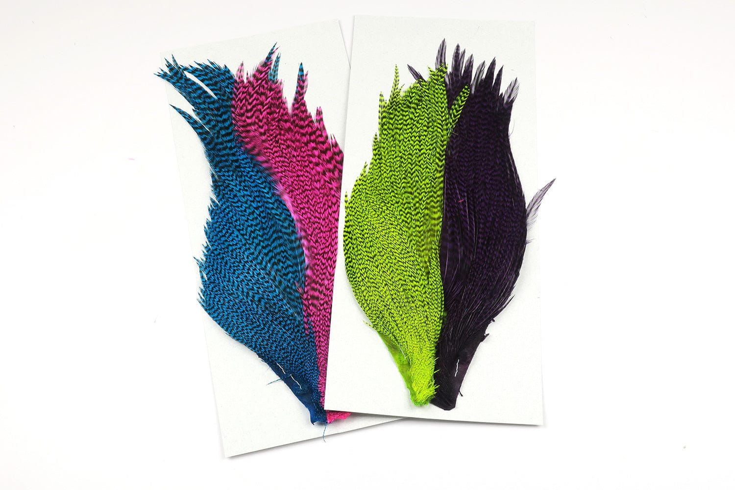 Hareline starter cape set of grizzly-dyed hackle feathers in blue, pink, chartreuse and purple on white cards for fly tying