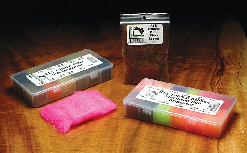 STS trilobal dubbing packs, fiery brown pack, clear dispensers, bright pink and multicolored fibers on wood — fly tying